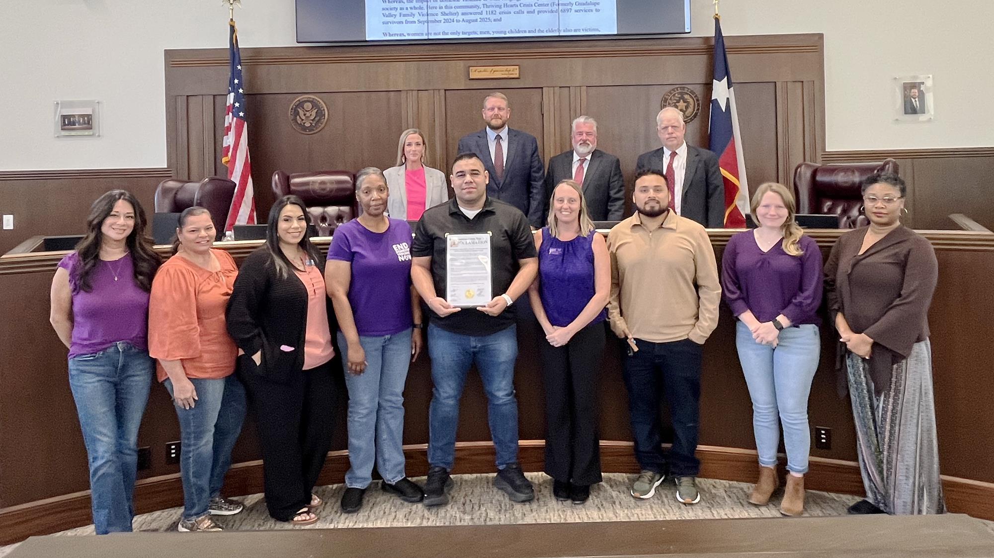 Photo of members of Thriving Hearts receive proclamation for October 2025 recognized as Domestic Violence Awareness Month in Guadalupe County, TX.